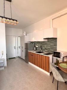 a kitchen with white cabinets and a table in it at Seafront Gonio Studio in Gonio +14 photos