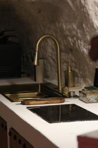 a kitchen counter with a sink and a counter top at L alcove des Sens Love Room Jacuzzi sauna in Tours +21 photos
