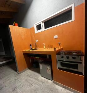 a small kitchen with a stove and a sink at Monoambiente de Playa in Camarones
