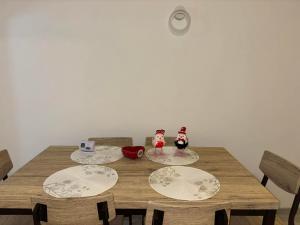 a wooden table with plates and figurines on it at La Sibip in Târgu Neamț