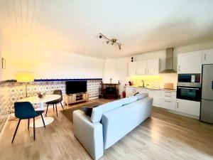 a living room with a couch and a table at Vila Pombal Tomar Apartments - Pool & City Views in Tomar
