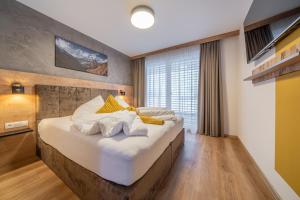 a bedroom with a large bed with a large window at Apart Dorhoam in Umhausen +61 photos