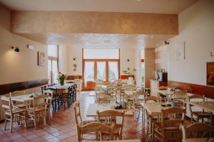 a restaurant with tables and chairs in a room at 3MÙZEN apartments in Tremosine Sul Garda
