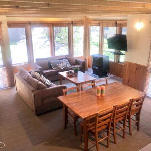 a living room with a couch and a table at Sun Apartments in Mount Hotham