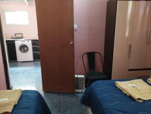 a room with a door and a washing machine at Rincones de la Puna in Antofagasta de la Sierra