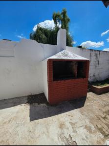 a brick oven on top of a white wall at Casa céntrica en JesusMaria in Jesús María