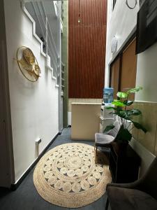 a hallway with a chair and a rug at Éclat Hotel Boutique in Iquique