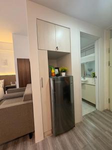 a living room with a refrigerator and a couch at 128 C Amani in Lapu Lapu City