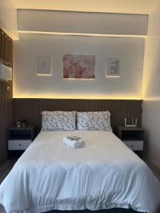 a bedroom with a bed with a white comforter at 128 C Amani in Lapu Lapu City +9 photos
