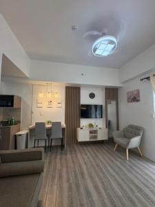 a living room with a couch and a table and chairs at 128 C Amani in Lapu Lapu City