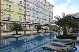 a swimming pool in front of a building at 128 C Amani in Lapu Lapu City