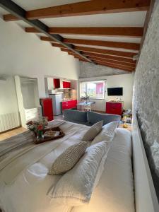 a large white bed with pillows in a room at Bahía de Pedreña 2 in Pedreña