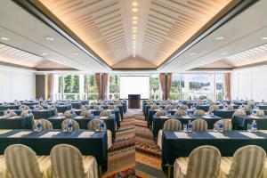 a large banquet hall with blue tables and chairs at Sheraton Okinawa Sunmarina Resort in Onna +152 photos