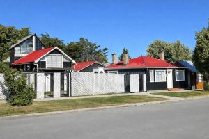a row of houses with red roofs on a street at Barso Home Puerto Natales in Puerto Natales