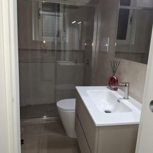 a bathroom with a toilet and a sink and a shower at Casa Bruno in Palermo