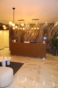 a lobby with a reception desk and a stone wall at WH HOTEL in San Andrés