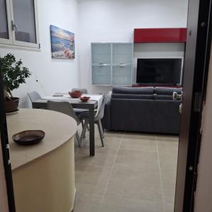 a living room with a couch and a table at Casa Bruno in Palermo +3 photos