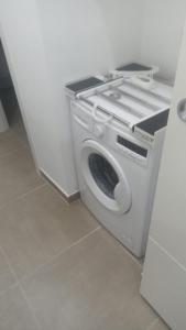 a washing machine is sitting in a room at Casa Bruno in Palermo