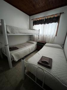 a bedroom with two bunk beds and a window at Cabañas de Mar - Calfu Huenu in Camarones