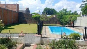 a swimming pool in a yard with a fence at Quinta Estrella in San Pedro