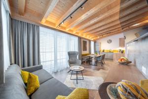 a living room with a couch and a table at Apart Dorhoam in Umhausen