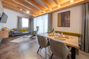 a living room with a table and a couch at Apart Dorhoam in Umhausen