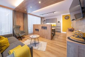 a living room with a couch and a table at Apart Dorhoam in Umhausen