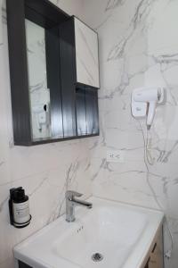 a white bathroom with a sink and a mirror at WH HOTEL in San Andrés +43 photos