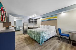 a hotel room with a bed and a desk at HomeTowne Studios by Red Roof Athens, TN in Athens +28 photos
