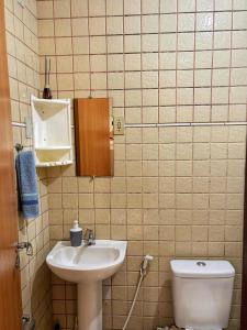 a bathroom with a sink and a toilet at Espaço Augusto in Barreirinhas +8 photos