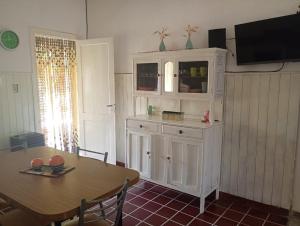 a dining room with a table and a white cabinet at Quinta Estrella in San Pedro +5 photos