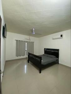 a black bed in a room with a ceiling at Casa Chonita in Tecuala