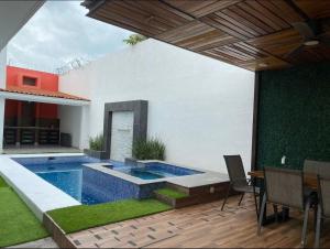 a backyard with a swimming pool and a house at Casa Chonita in Tecuala