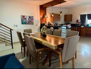 a kitchen and dining room with a wooden table and chairs at Casa Chonita in Tecuala