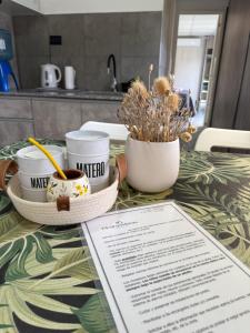a table with two cups of coffee and plants on it at Piedras Moras cabañas in Almafuerte