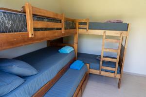 a bedroom with two bunk beds and a ladder at Piedras Moras cabañas in Almafuerte +23 photos