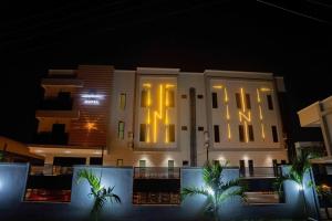 a large white building with its lights on at night at Nirvana City Hotel in Benin City