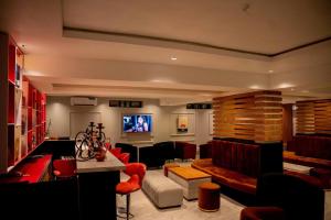 a living room filled with furniture and a flat screen tv at Nirvana City Hotel in Benin City