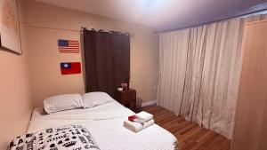 a bedroom with a bed and a window with an american flag at Cozy House Nested Around Trees E in San Jose