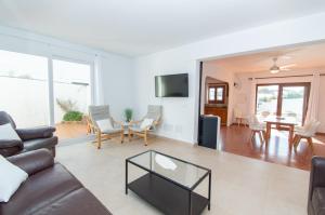 a living room with a couch and a table at Villa Can Canaleta by Sonne Villas in Cala Galdana