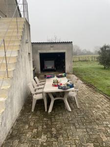 a table and chairs in front of a fireplace at Voyage in Ouroux-sur-Saône +1 photo