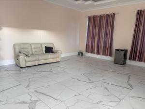 a living room with a couch on a marble floor at Comfortable Private Room in a Shared Home in Richmond