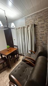 a living room with a couch and a table at RE2 Alojamientos in Real de San Carlos