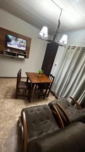 a living room with a table and a couch and a television at RE2 Alojamientos in Real de San Carlos