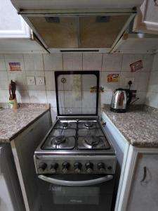 a kitchen with a stove top oven in a kitchen at Ajman Downtown Central AISOOGA in Ajman 