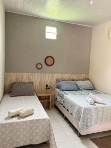 two beds sitting next to each other in a bedroom at Espaço Augusto in Barreirinhas