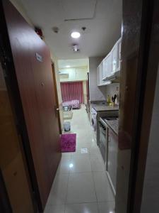 a kitchen with a hallway leading to a kitchen with at Ajman Downtown Central AISOOGA in Ajman  +15 photos