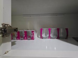 a row of empty glasses sitting on a counter at Ajman Downtown Central AISOOGA in Ajman 