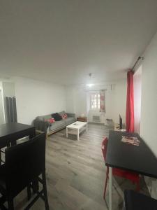 a living room with a couch and a table at Compostelle Chemin Garazi in Uhart-Cize