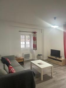 a living room with a couch and a table at Compostelle Chemin Garazi in Uhart-Cize